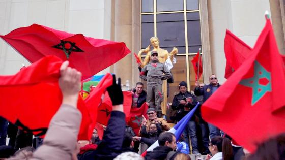Demonstrators wave Moroccan flags during a protest in Paris, Sunday, March 20, 2016. The United States is declaring its support for the threatened U.N. peacekeeping mission in the disputed territory of Western Sahara after Morocco took steps to reduce its size and terminate $3 million in funding. (AP Photo/Christophe Ena)